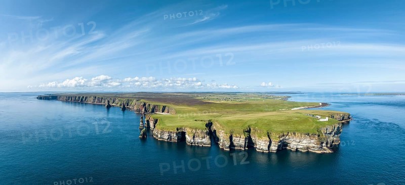 Aerial panorama of the rugged coastal landscape at Duncansby Head with the lighthouse on the right, the Duncansby Stacks rock formation on the left, Scotland's north-eastern point, County Caithness, Scotland, United Kingdom, Europe