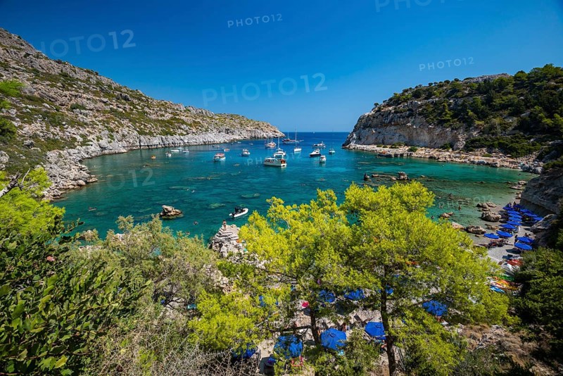 Beach umbrellas and sunbeds, turquoise waters, Anthony Quinn Bay, Faliraki, Rhodes, Dodecanese, Greece, Europe