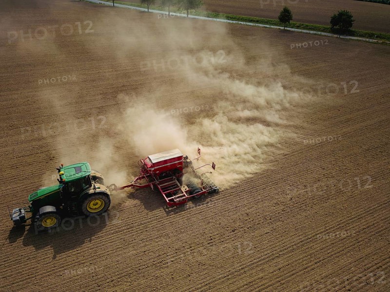 A tractor with a Horsch PRONTO DC 6 seed drill sowing in a dry field in late summer., Doma, Saxony, Germany, Europe