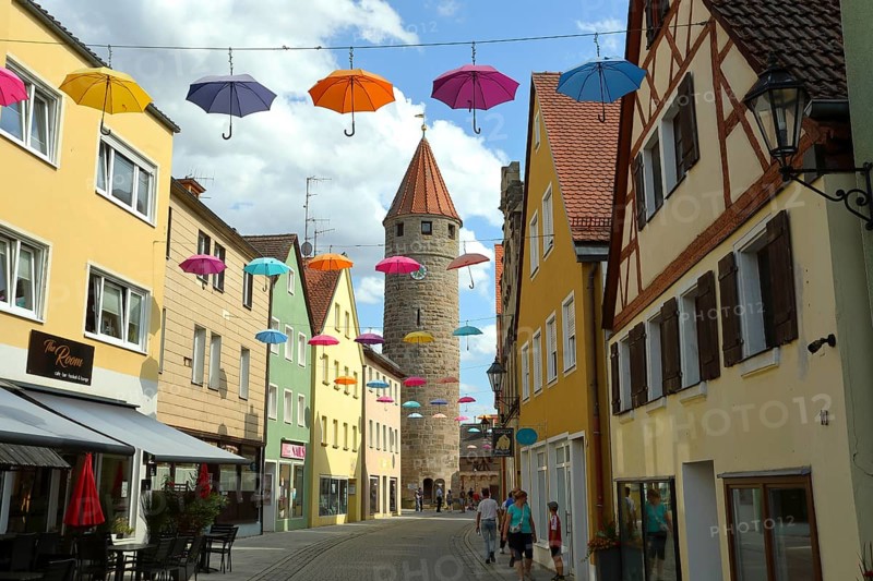 FÃ¤rberturm also called Pulverturm, coloured umbrellas in the sky, Gunzenhausen, Altmühltal, Franconian Lake District, Franconia, Bavaria, Germany, Europe