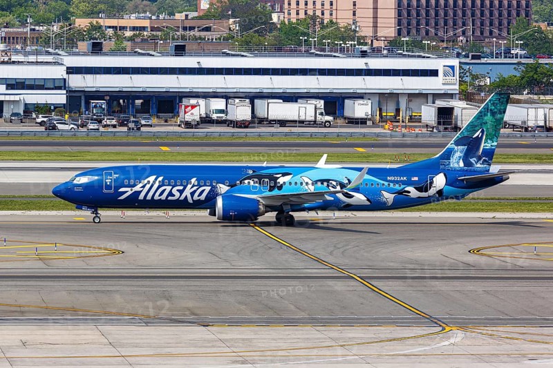 A Boeing 737-9 MAX aircraft of Alaska Airlines with the registration number N932AK and the West Coast Wonders special livery at New York John F Kennedy (JFK) Airport in New York, USA, North America