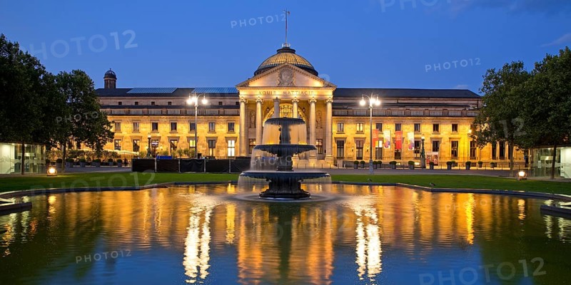 Illuminated spa hotel and Casino in the evening with cascade fountain, Wiesbaden, Hesse, Germany, Europe