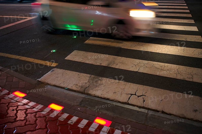 Night shot, pedestrian crossing, zebra crossing, against smartphone junkies, with ground traffic light, ground traffic light, LED lights red and green in the asphalt, cars, motion effect, wipe effect, traffic, Dubai, United Arab Emirates, VAR, Asia