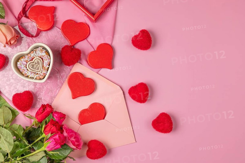 Heart-shaped cupcake, red hearts and roses around an envelope, Valentine's Day, pink background