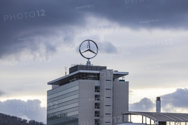 Mercedes star in front of dark clouds, office building at the headquarters of Mercedes-Benz Group AG in Untertürkheim, Stuttgart, Baden-Württemberg, Germany, Europe