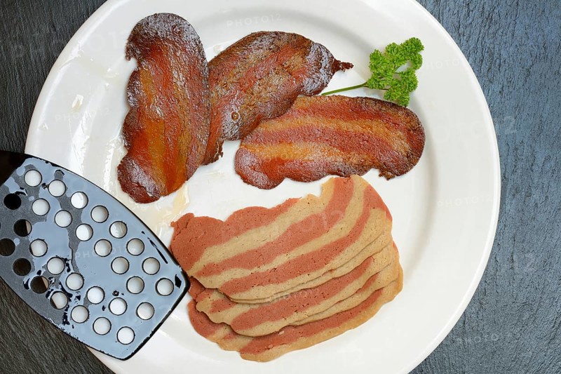 Artificial bacon as imitation meat, imitation bacon on plate, meat substitute