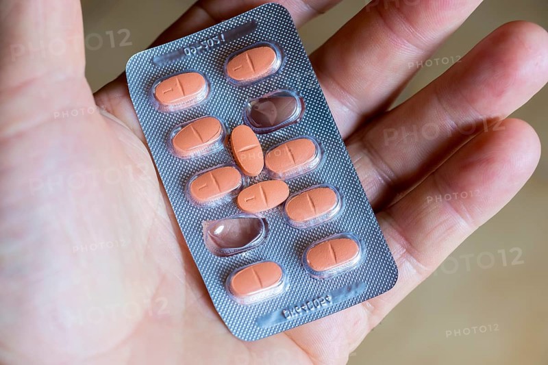 Hand holding a blister pack with tablets