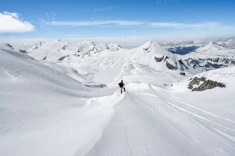 Ski tourers ascending to the Wildstrubel hut, snow-covered mountain landscape with Mittaghorn and Wildstrubel peaks, Bernese Alps, Switzerland, Europe