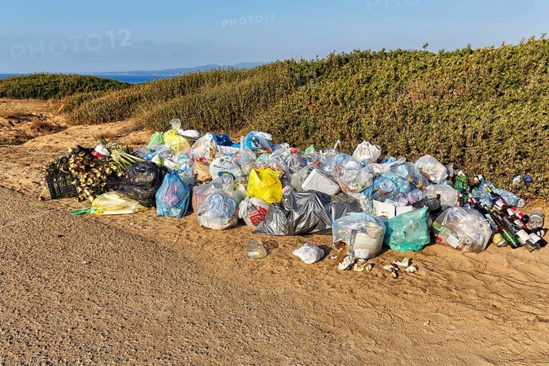 Mountain of rubbish, rubbish bags, plastic waste and old glass in front of a dune landscape by the sea, Costa Verde, western Sardinia, Sardinia, Italy, Europe