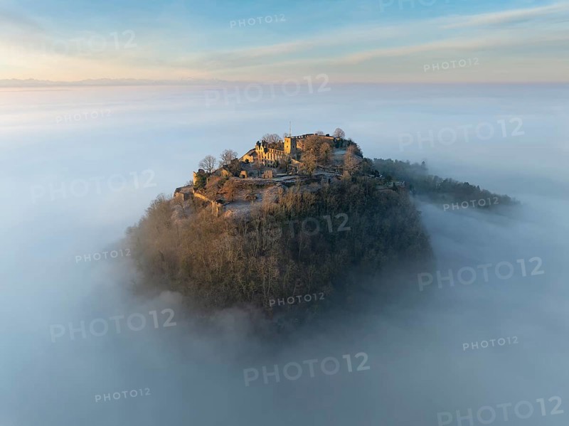 Aerial view of the Hegau volcano Hohentwiel with the upper fortress ruins illuminated by the rising sun, rising out of the fog during an inversion, district of Constance, Baden-Württemberg, Germany, Europe