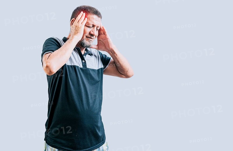 Senior man with headache isolated. Senior person with migraine holding his head isolated