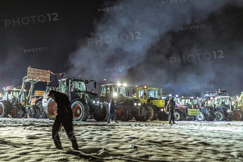 Tractors during a rally as part of the farmers' protests on the snow-covered Kirchbichl, Schliersee, Upper Bavaria, Bavaria, Germany, Europe