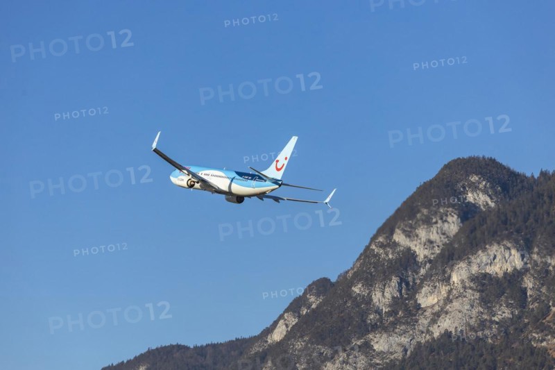 TUI airline aircraft taking off at Innsbruck Kranebitten Airport, Boeing 737-800. Snow-covered mountains of the Alps, Innsbruck, Tyrol, Austria, Europe