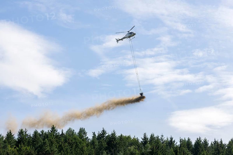 Symbolic image, climate change, helicopter, helicopter spreading finely painted limestone and wood ash against acid rain, mixed forest, container, soil protection liming, forest liming, Baden-Württemberg, Germany, Europe