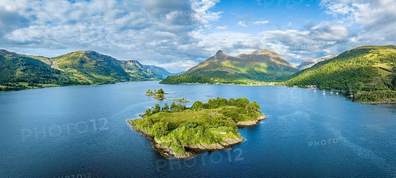 Aerial panorama of the western part of Loch Leven with the historic island of Eilean Munde, above it the 742 metre high Pap of Glencoe, Highlands, Scotland, United Kingdom, Europe