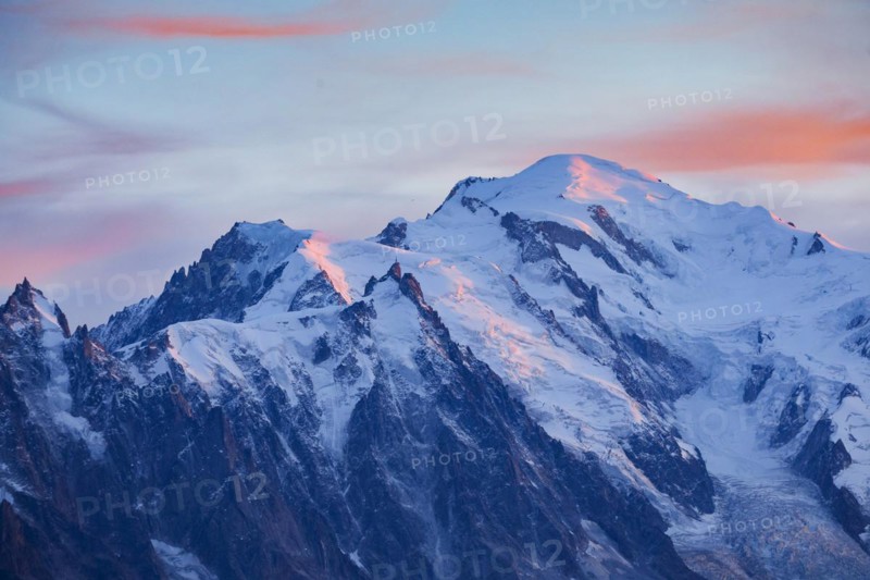 Red-coloured clouds over the summit of Mont Blanc with Aiguille du Midi in the foreground, Savoie, France, Europe