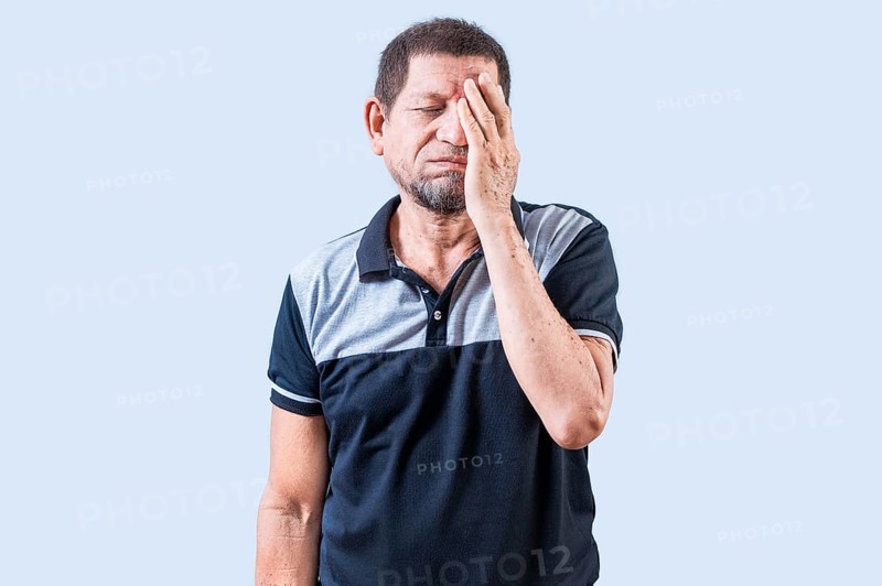 Tired and exhausted old man covering his face with the palm of his hand. Exhausted senior man putting the palm on his face