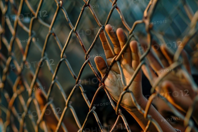 Hands of desperate immigrant on chain link fence. KI generiert, generiert, AI generated