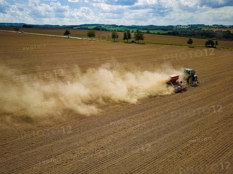 A tractor with a Horsch PRONTO DC 6 seed drill sowing in a dry field in late summer., Doma, Saxony, Germany, Europe