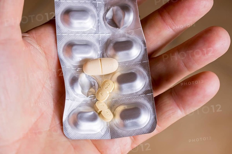 Hand holding a blister pack with tablets