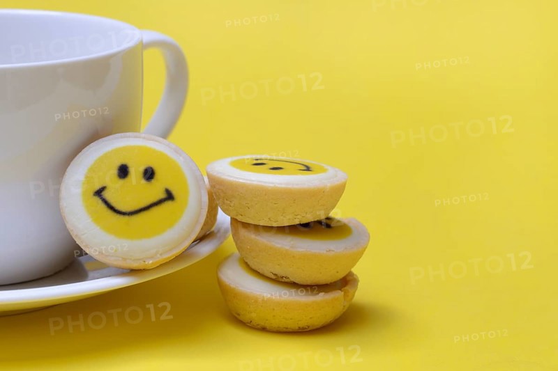 Pastry with smiley face and coffee cup, symbol