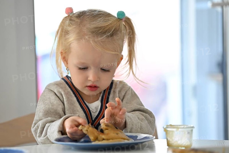 Little girl, 2 years, blonde, eats pancakes, pancake, plate, spoon, eat, Stuttgart, Baden-Württemberg, Germany, Europe