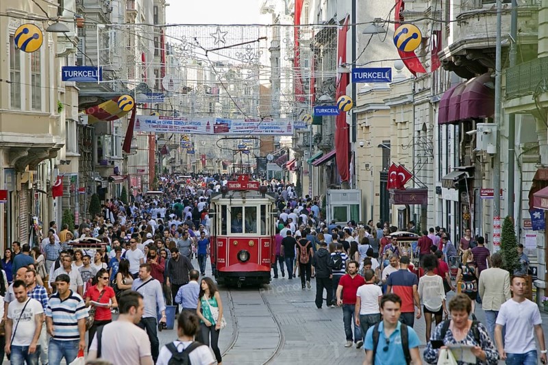 Historic tram in Istiklal Avenue, busy shopping street near Taksim square in the city Istanbul, Turkey, Asia