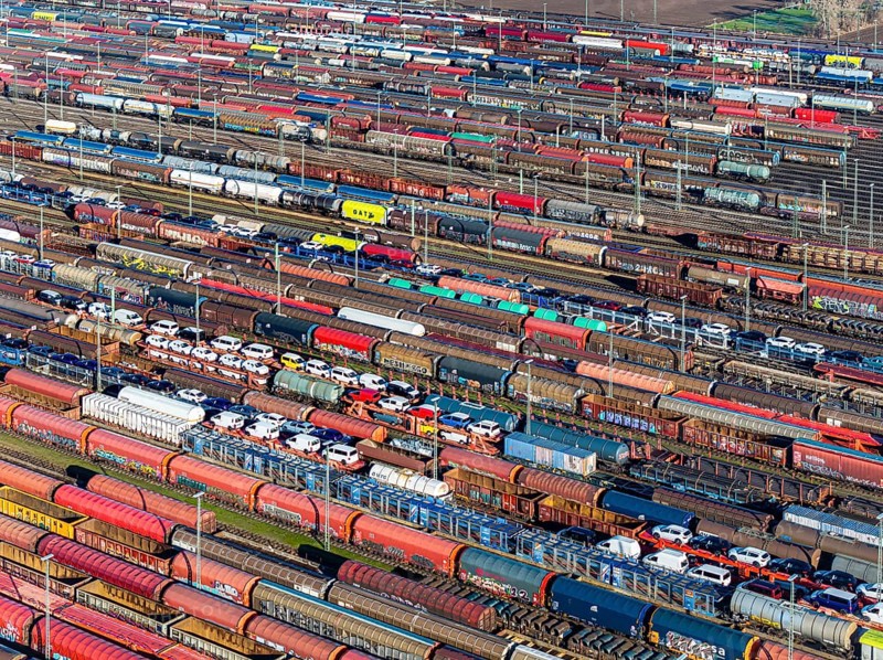Deutsche Bahn AG marshalling yard. Many goods trains are parked on the tracks with tank wagons, car transporters and other wagons, companies transport a considerable part of their freight by rail, aerial view, Germany, Europe