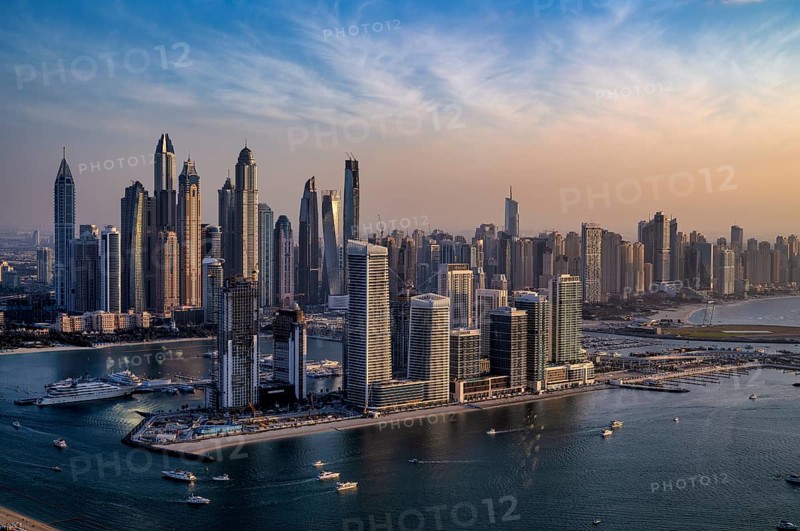 View from The View At the Palm viewing platform onto skyline with Princess Tower, Elite Residence, luxury yacht OPERA owned by Sheikh Mansour bin Zayed Al Nahyan from the ruling family of the Emirate of Dubai, anchored in front of EMAAR Beachfront, Logo, evening mood, Dubai Marina, Dubai, United Arab Emirates, VAR, Asia