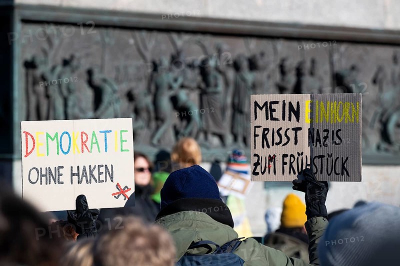 Pictures taken during the demonstration Haltung zeigen! against Nazi deportation plans of the AfD on the Schlossplatz in Stuttgart, 20 January 2024. A sign with the inscription Demokratie ohne Haken and Mein Einhorn eats Nazis for breakfast