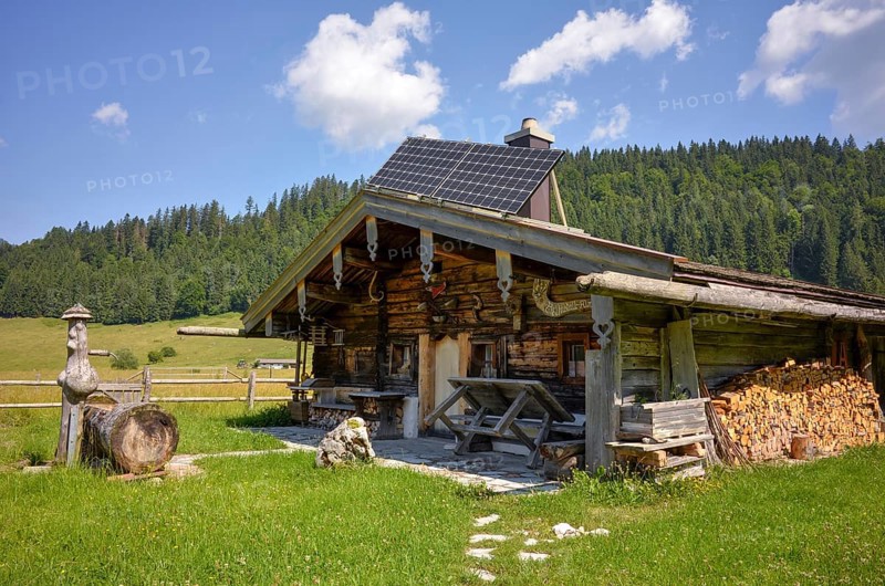 Alpine hut with well and solar panels on the Rötelmoosalm, Chiemgau, Bavaria, Germany, Europe