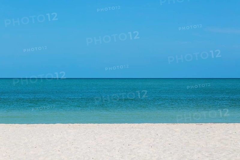 Sandy beach with blue sky and horizon of calm sea, Gulf of Mexico coast, Celestun, Yucatan, Mexico, Central America