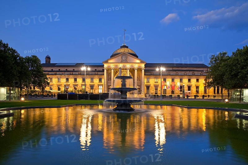 Illuminated spa hotel and Casino in the evening with cascade fountain, Wiesbaden, Hesse, Germany, Europe
