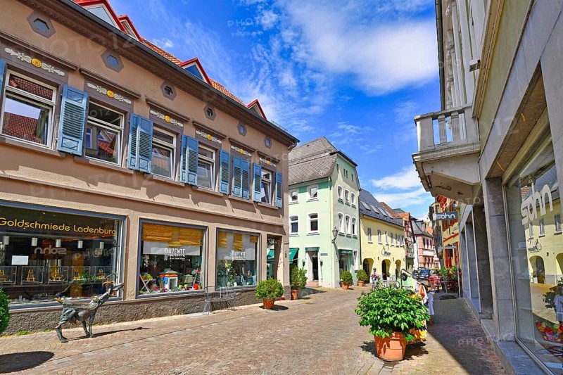 Ladenburg, Germany, July 2020: Mains treet with shops in historical city center dating back to Middle Age of small German town Ladenburg on sunny summer day, Europe