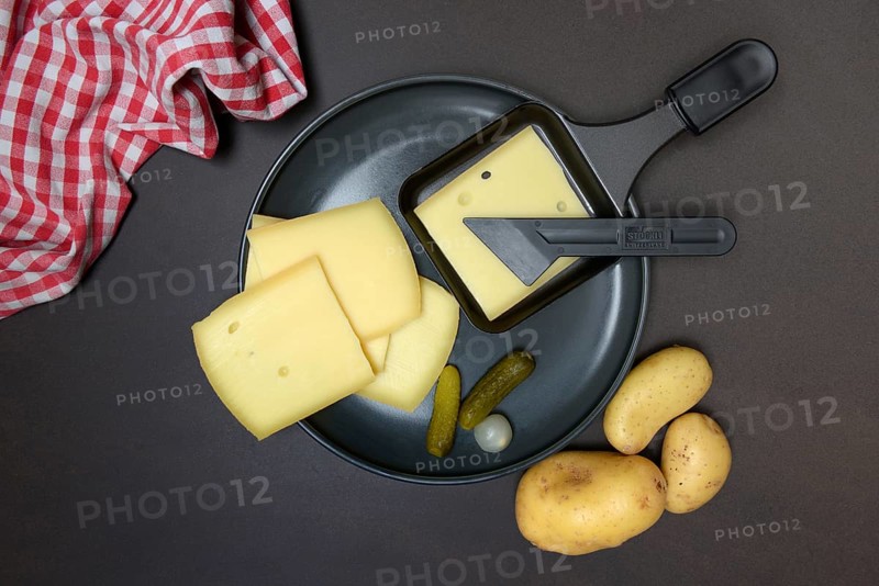 Raclette, cheese slices in raclette pans, Switzerland, Europe