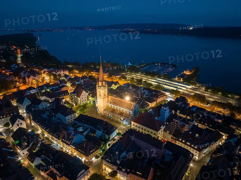 Aerial view of the city of Radolfzell at night with the illuminated Radolfzell Minster, Radolfzell am Lake Constance, Landkreis Konstanz, Baden-Württemberg, Germany, Europe