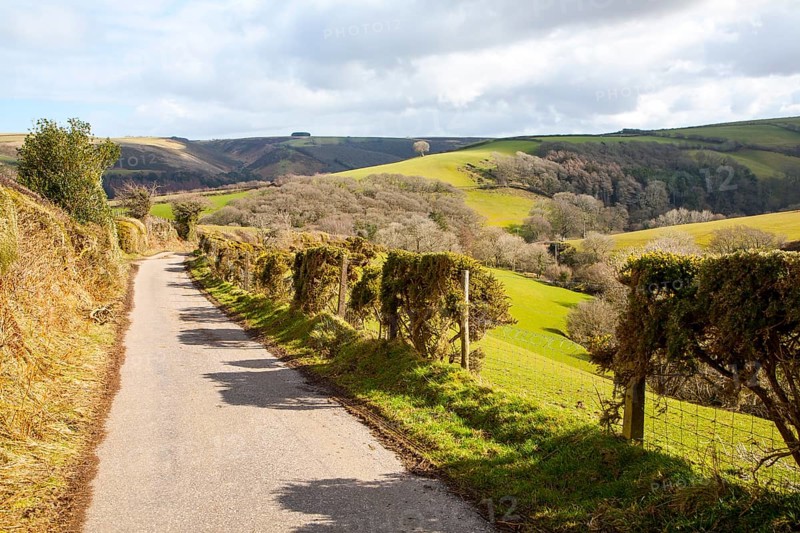 Narrow road leading into Exmoor national park landscape, near Malmsmead, Devon, England, United Kingdom, Europe