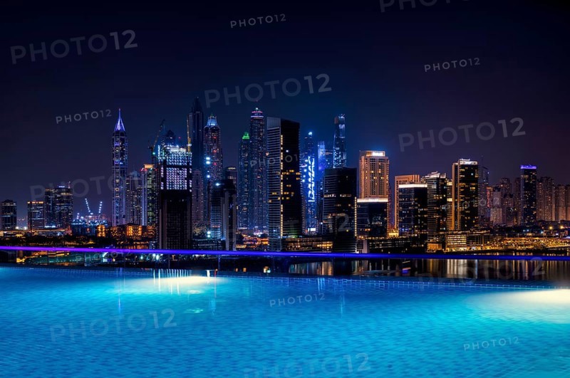 Night shot rooftop pool, swimming pool, Dubai Marina skyline behind, Hotel NH Collection The Palm Jumeirah, Dubai, United Arab Emirates, VAR, Asia