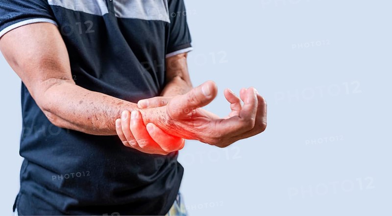 Elderly person with arthritis in hands on isolated background. Hands of elderly people with arthritis and pain