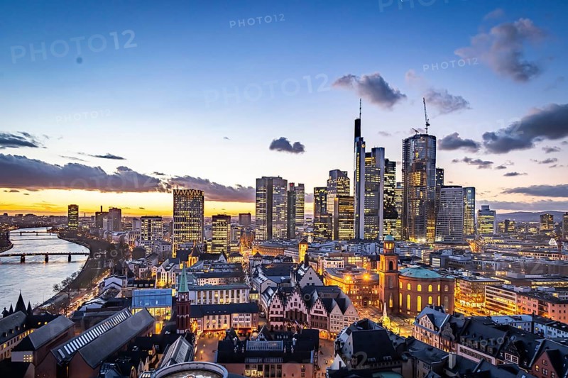 View of the banking district in the evening, skyscrapers of the credit institutions, Mainhatten, in front of it the historic old town with Römer and Paulskirche, Frankfurt am Main, Hesse, Germany, Europe