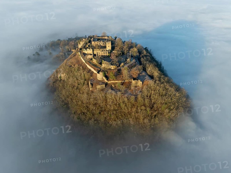 Aerial view of the Hegau volcano Hohentwiel with the upper fortress ruins illuminated by the rising sun, rising out of the fog during an inversion, district of Constance, Baden-Württemberg, Germany, Europe