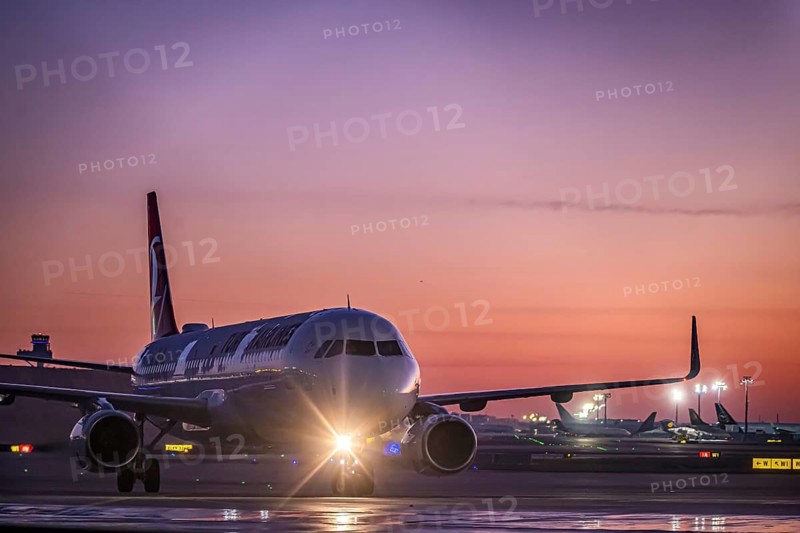 Frost at the airport, a Turkish Airlines aircraft is de-iced in front of sunrise. Airbus A321-231, Fraport, Frankfurt am Main, Hesse, Germany, Europe