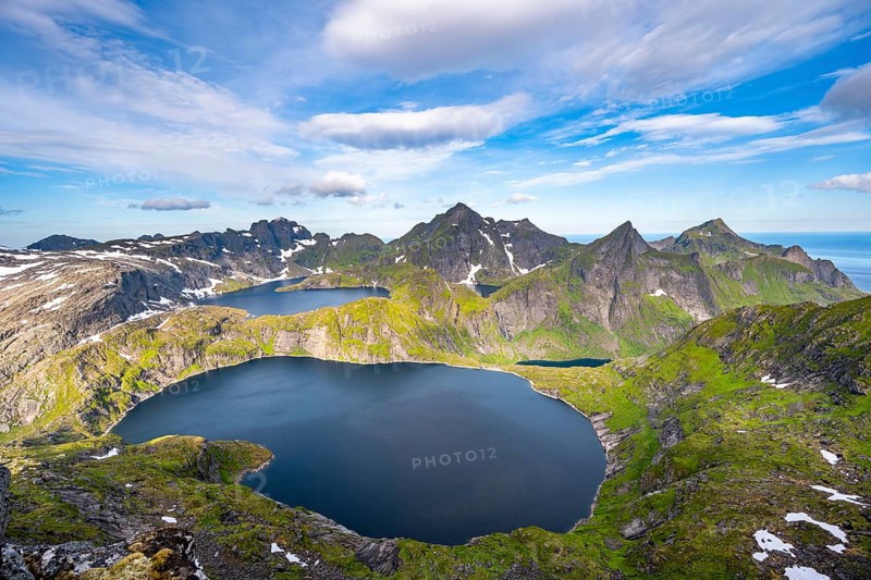 Mountain landscape with steep rocky peaks and lake Tennesvatnet and Krokvatnet, in the back peak of Hermannsdalstinden, view from the top of MunkenMoskenesoya, Lofoten, Nordland, Norway, Europe
