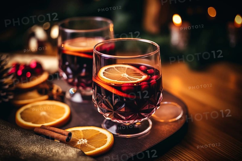 Two glasses of traditional mulled wine with orange and cranberry garnishes on a cozy Christmas table. The background is blurred with bokeh lights and candles, creating a warm and festive atmosphere, AI generated