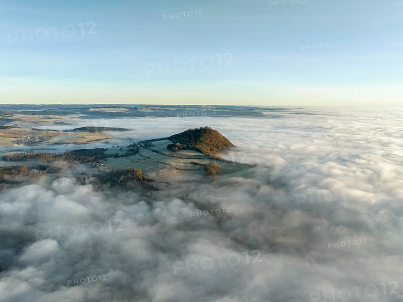 Aerial view of the wintry and fog-covered Hegaulandschaft shortly after sunrise, the volcanic cone Hohenhewen rises out of the sea of fog, district of Constance, Baden-Württemberg, Germany, Europe