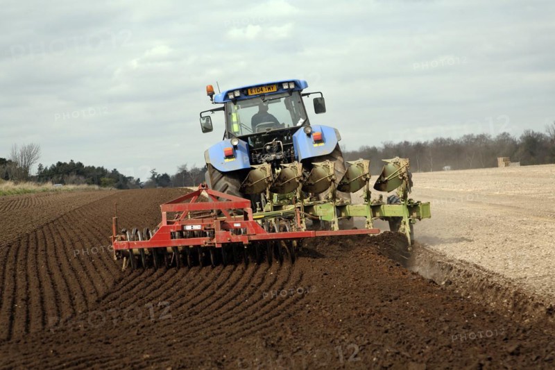 New Holland tractor disc harrowing field, Sutton, Suffolk, England, United Kingdom, Europe