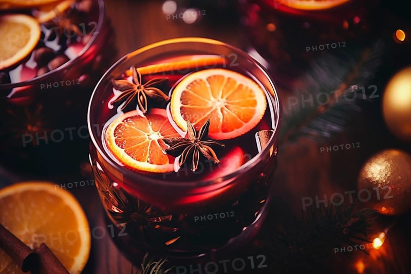 Glass of traditional mulled wine with orange and cranberry garnishes on a cozy Christmas table. The background is blurred with bokeh lights and candles, creating a warm and festive atmosphere, AI generated