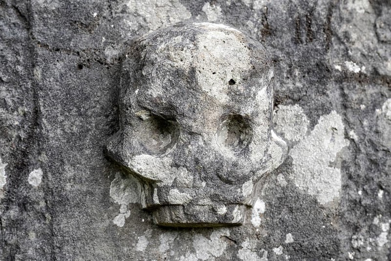 Chiselled skull as decoration on an old weathered gravestone, Kilmartin, Argyll and Bute, Scotland, Great Britain