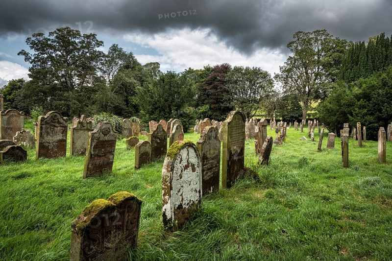 Weathered gravestones in the old graveyard of the monastic ruins of Lanercost Priory, County Cumbria, England, Great Britain