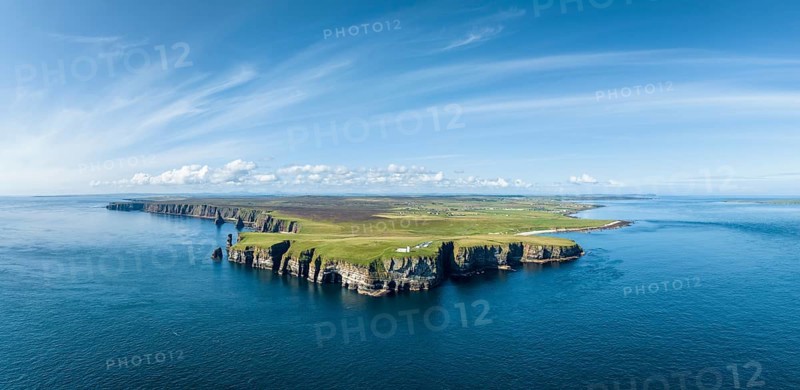 Aerial panorama of the rugged coastal landscape at Duncansby Head with the lighthouse, Duncansby Stacks rock formation on the left, John o' Groats village on the horizon on the right, Scotland's north-eastern point, County Caithness, Scotland, United Kingdom, Europe